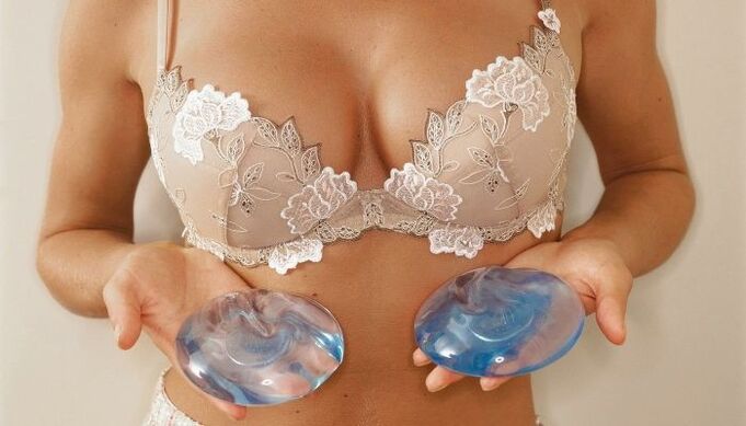 girl holding an implant for breast augmentation