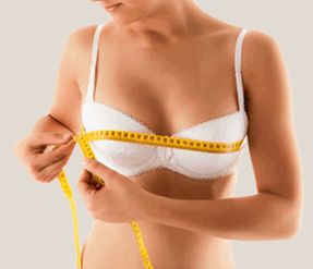 The girl measures the breasts with one centimeter